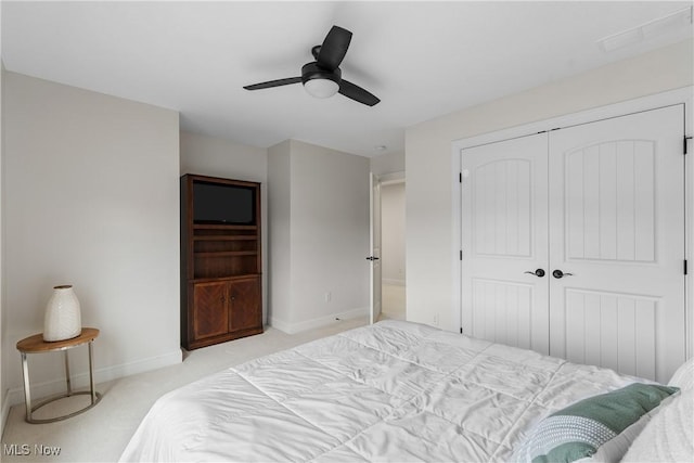 carpeted bedroom with ceiling fan and a closet