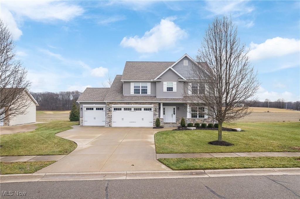 craftsman-style house featuring a garage and a front yard