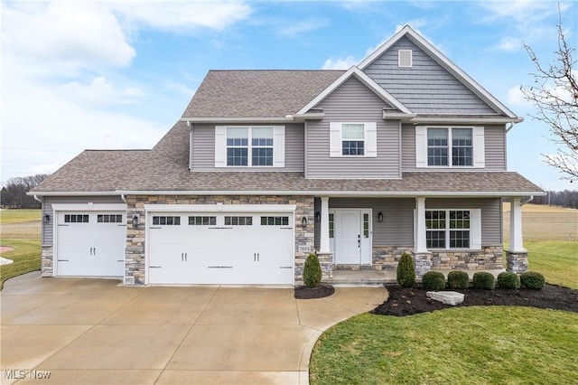 craftsman-style home featuring a garage, a front lawn, and covered porch