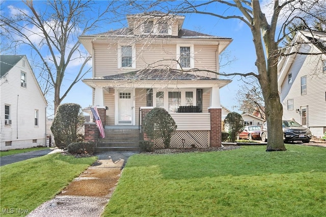 front facade with a front lawn and a porch