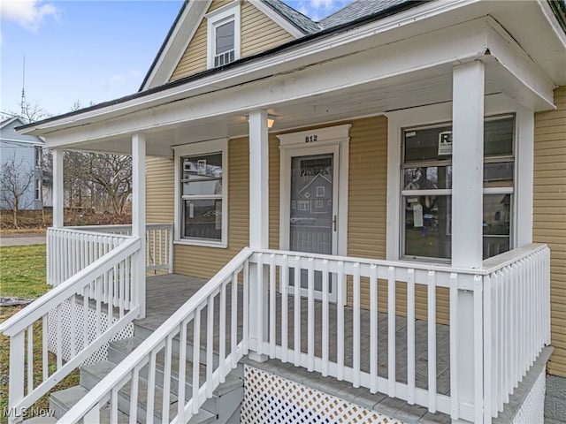 view of exterior entry with a porch