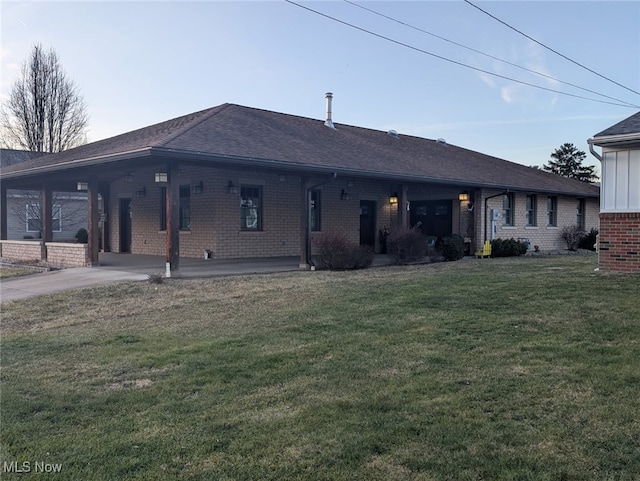 back of house with a yard and a carport