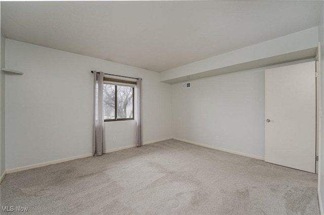 unfurnished room featuring light colored carpet