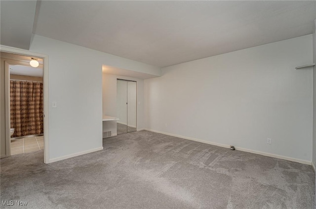 unfurnished room with light colored carpet