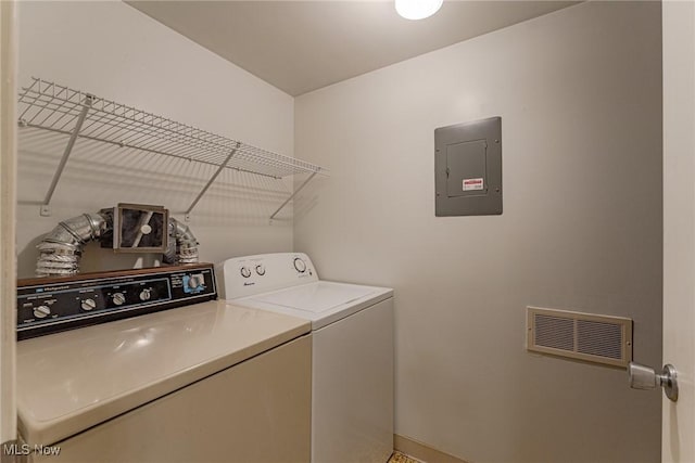 washroom with independent washer and dryer and electric panel