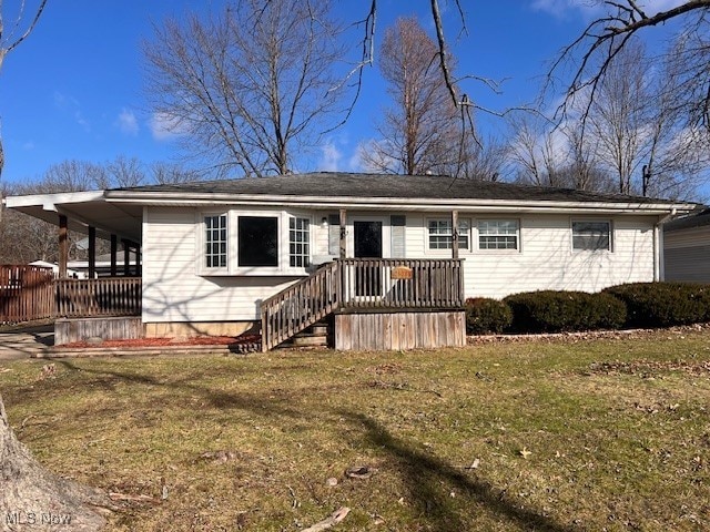 single story home featuring a wooden deck and a front yard