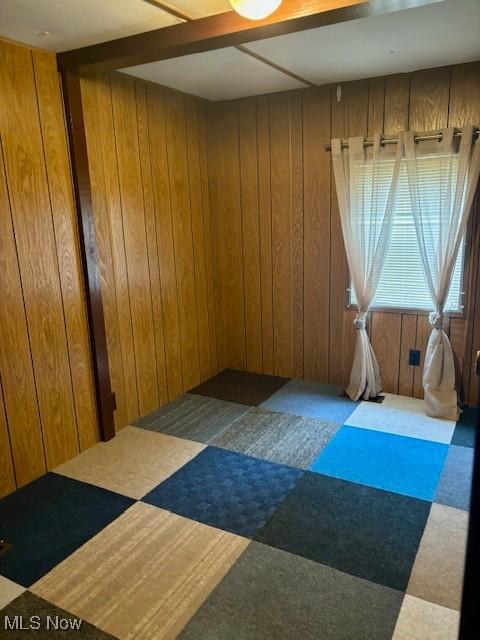 empty room featuring wood walls