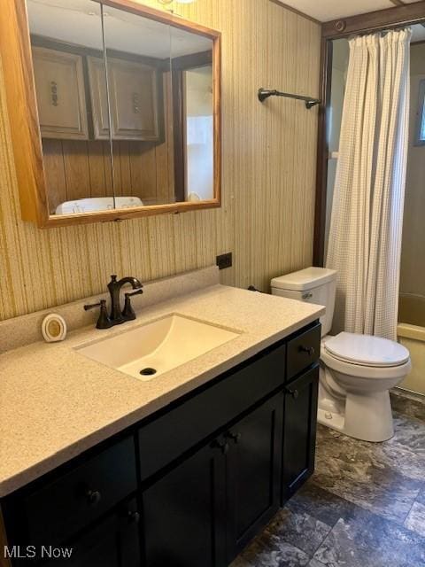 full bathroom with vanity, shower / bath combo with shower curtain, and toilet