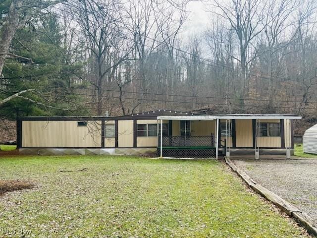 view of front of home with a front yard and covered porch