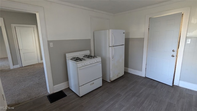 kitchen with crown molding, dark wood-type flooring, and white appliances