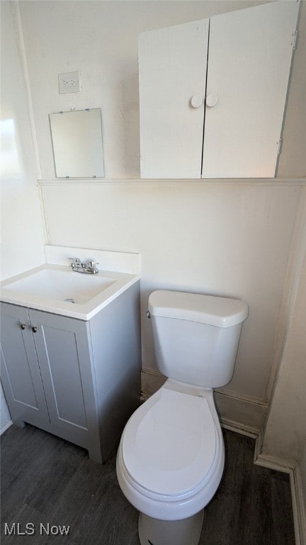 bathroom with vanity, hardwood / wood-style flooring, and toilet