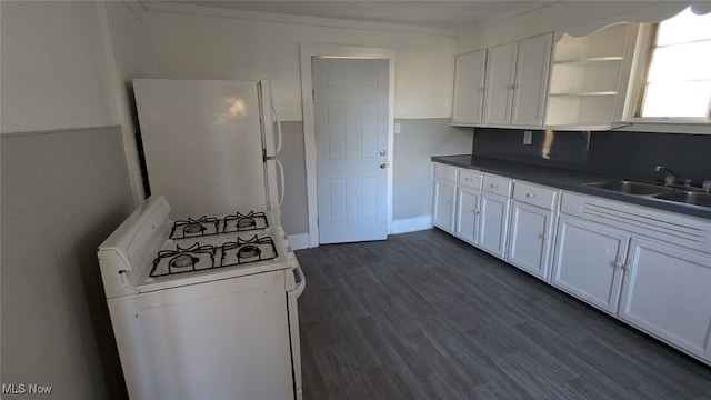 kitchen featuring dark hardwood / wood-style floors, white cabinetry, sink, and white appliances