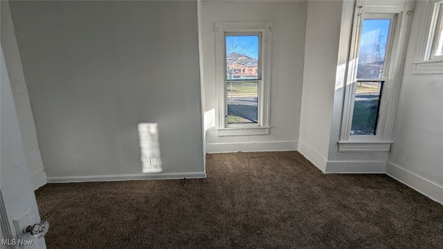 empty room featuring dark carpet