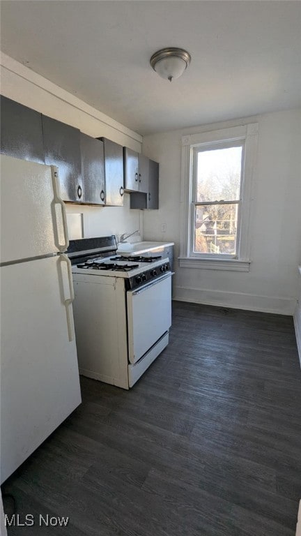 kitchen with white appliances and dark wood-type flooring