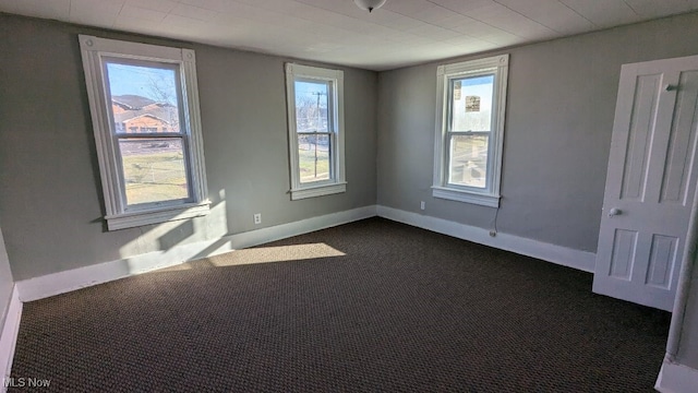 empty room featuring dark carpet