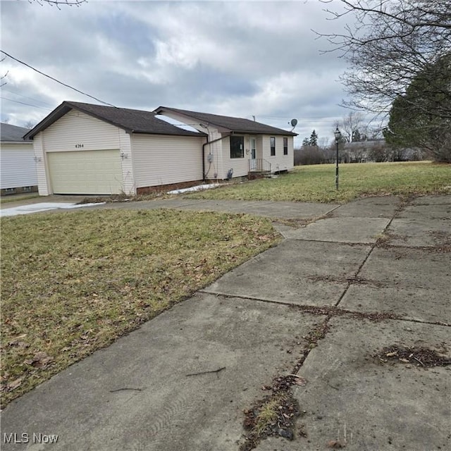 ranch-style house with a garage and a front lawn