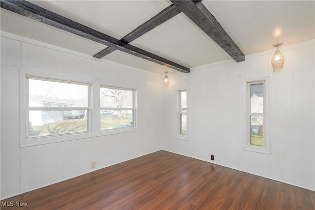 spare room with dark wood-type flooring and beamed ceiling