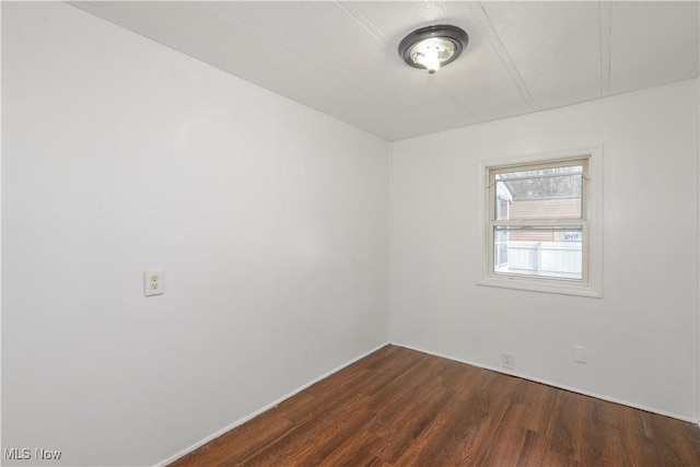 empty room with dark wood-type flooring