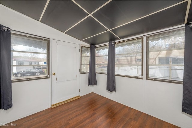 empty room with dark hardwood / wood-style flooring