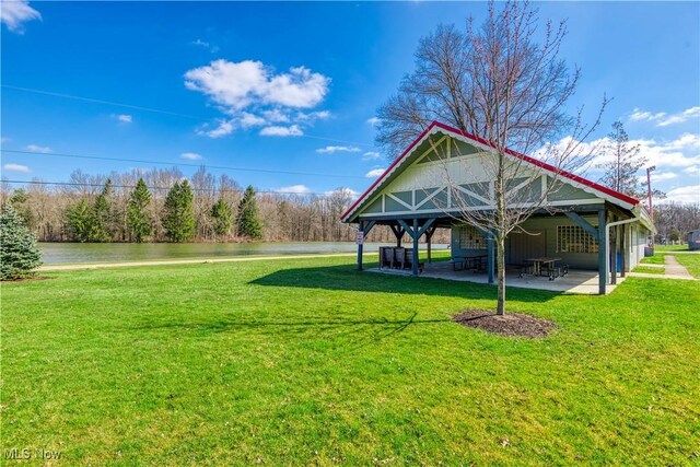 view of home's community featuring a lawn and a patio area