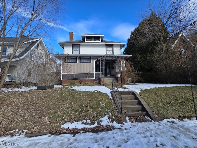 view of front of house featuring a yard and covered porch