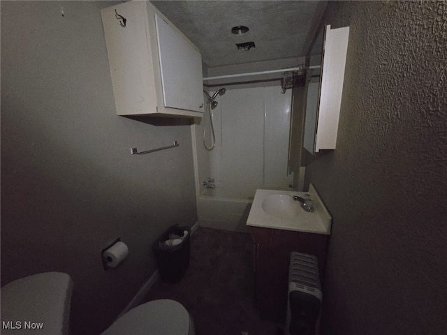 full bathroom with washtub / shower combination, vanity, toilet, and radiator