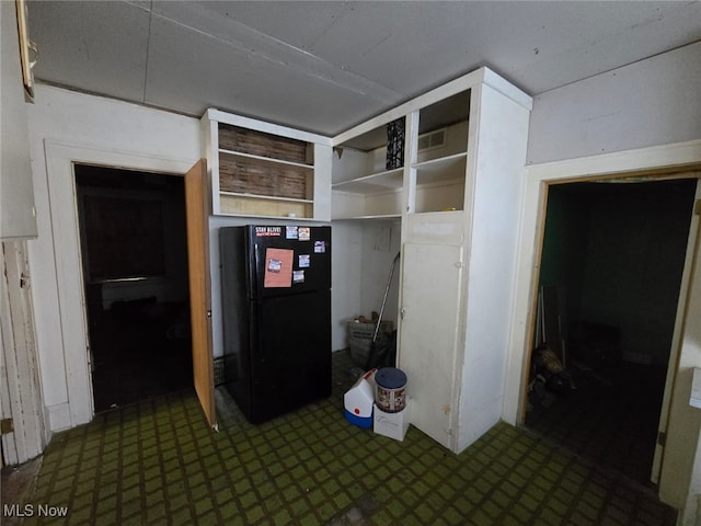 kitchen featuring black refrigerator