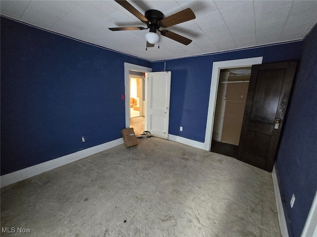 unfurnished bedroom featuring a closet, ceiling fan, and carpet