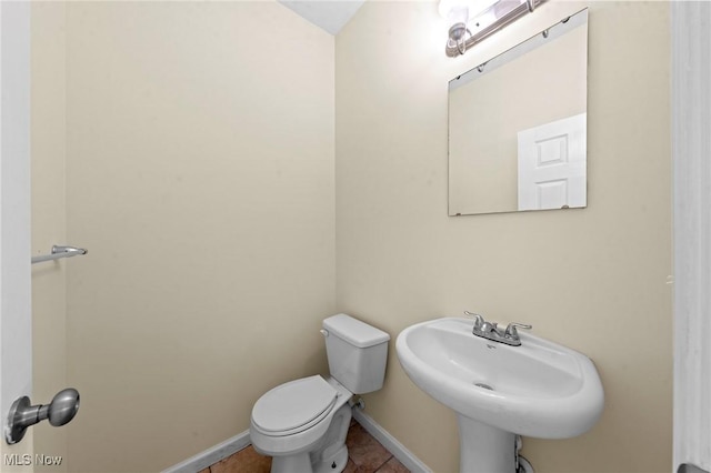 bathroom with sink, tile patterned floors, and toilet