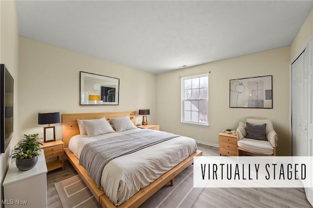 bedroom featuring hardwood / wood-style floors and a closet