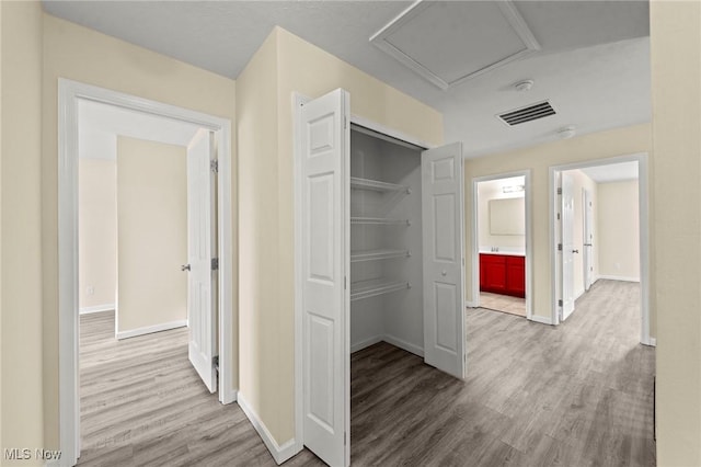 corridor featuring light hardwood / wood-style floors