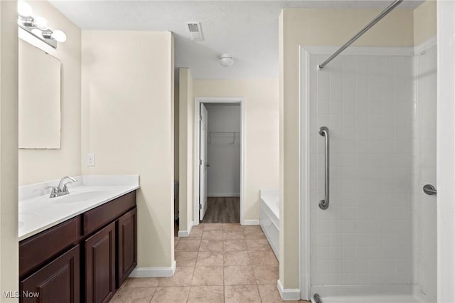 bathroom with vanity, shower with separate bathtub, and tile patterned flooring