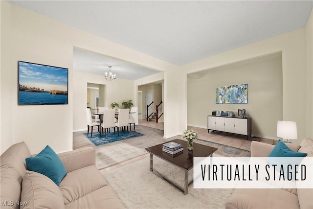 living room with a notable chandelier and light wood-type flooring