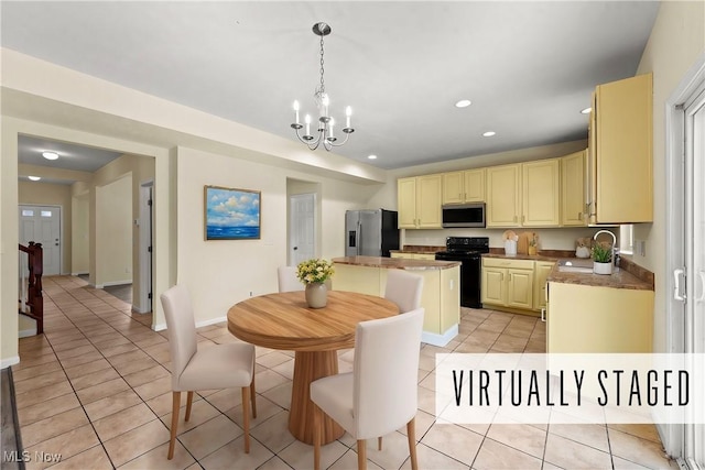 kitchen featuring light tile patterned flooring, sink, decorative light fixtures, a kitchen island, and stainless steel appliances