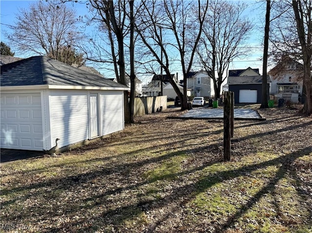 view of yard featuring a garage and an outdoor structure