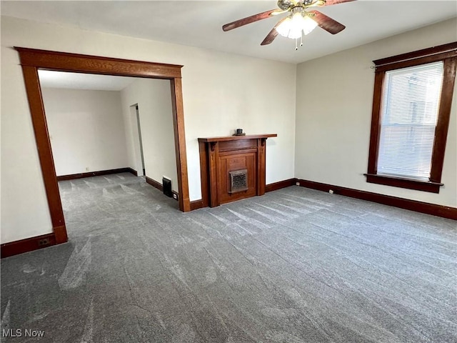 unfurnished living room featuring dark colored carpet and ceiling fan