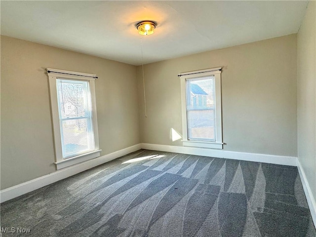 carpeted empty room featuring plenty of natural light