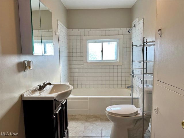 full bathroom with vanity, toilet, tiled shower / bath combo, and plenty of natural light