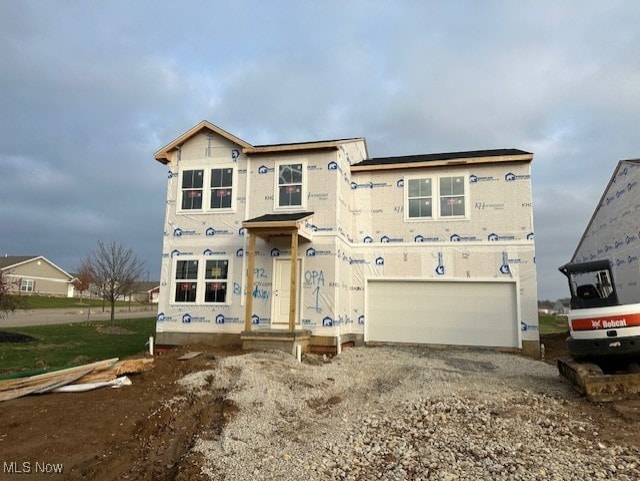 unfinished property featuring a garage