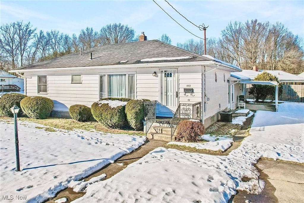 view of snow covered rear of property