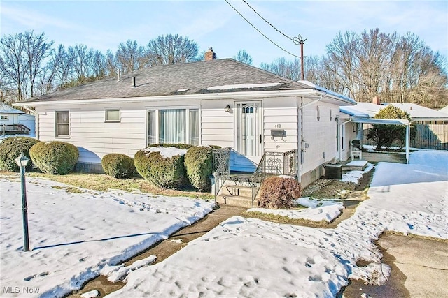 view of snow covered rear of property