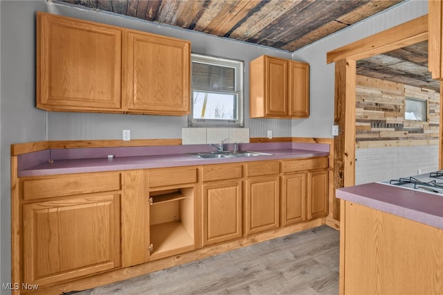 kitchen with light hardwood / wood-style flooring, sink, wood ceiling, and wooden walls