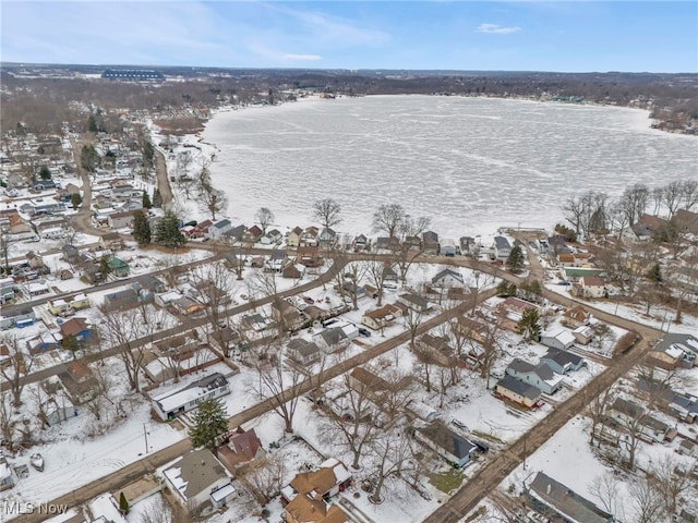 snowy aerial view featuring a water view