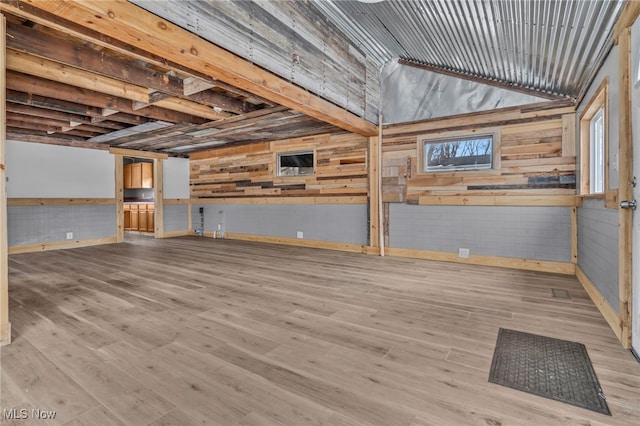 interior space featuring wood walls and light wood-type flooring