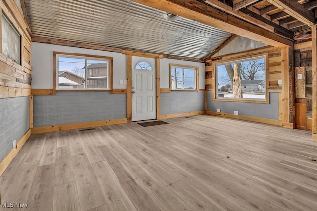 interior space with lofted ceiling and light hardwood / wood-style flooring