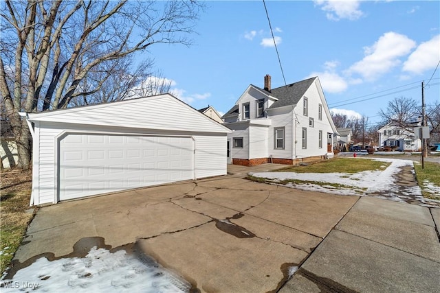 view of property exterior with a garage and an outdoor structure