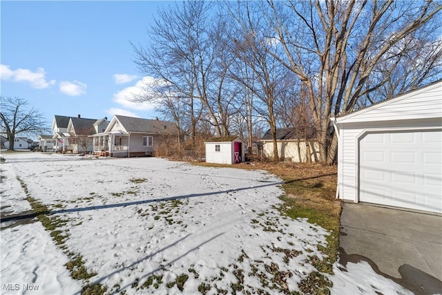 snowy yard with a storage unit