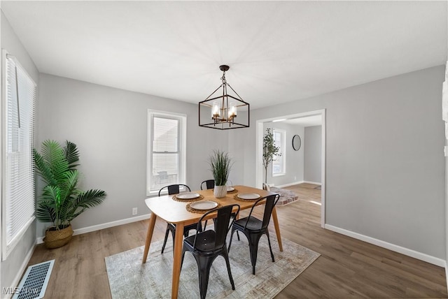 dining room featuring hardwood / wood-style floors and a notable chandelier