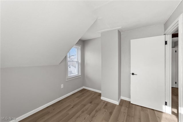 bonus room with lofted ceiling and hardwood / wood-style flooring