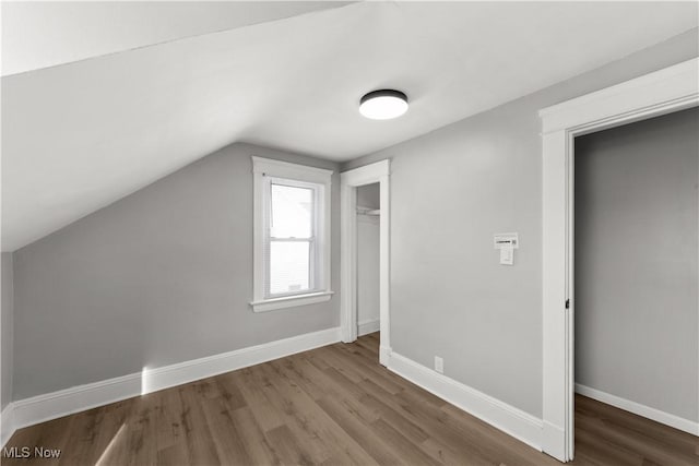 bonus room featuring wood-type flooring and lofted ceiling